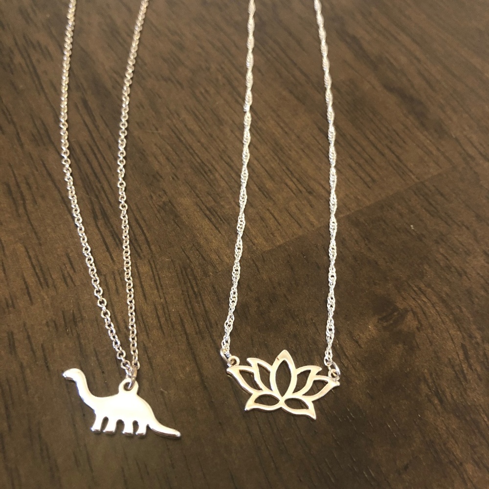 Lotus and dinosaur necklaces